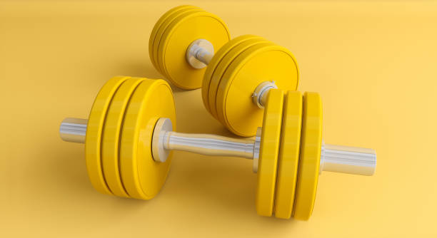 istock yellow dumbbells on a yellow background close-up 1161913573