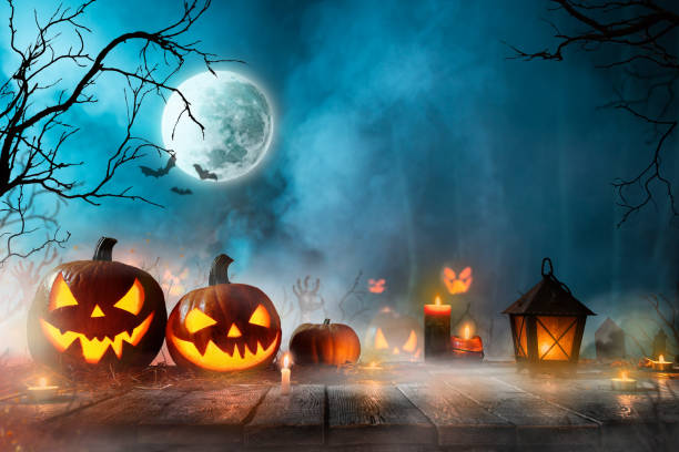 istock Halloween pumpkins on dark spooky forest. 1161914746