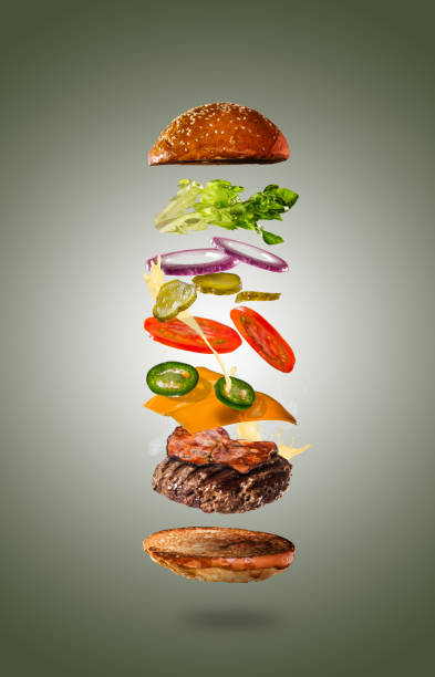 istock Tasty cheeseburger with flying ingredients on color pastel background 1161914861