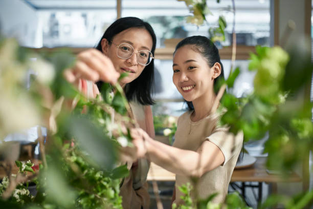 Female Asian Florists Working Together on Arrangement