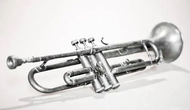 Photo of An ancient jazz trumpet on a white background