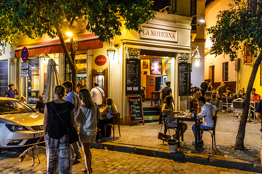 Seville, Spain - September 3rd 2015: People dining at a restaurant in the old city. The area is a popular evening venue.