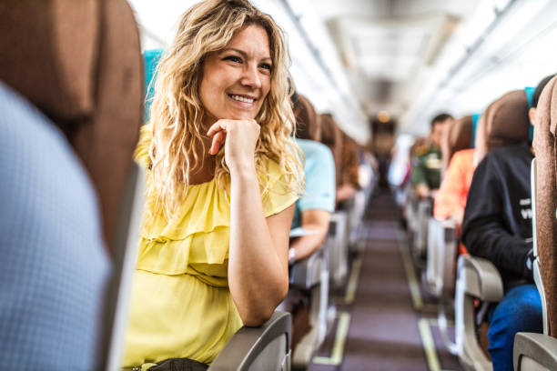 istock Young happy woman enjoying while traveling by airplane. 1161921397