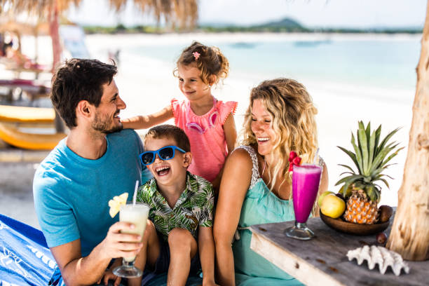 istock Happy parents having fun with their kids in a beach cafe. 1161921521