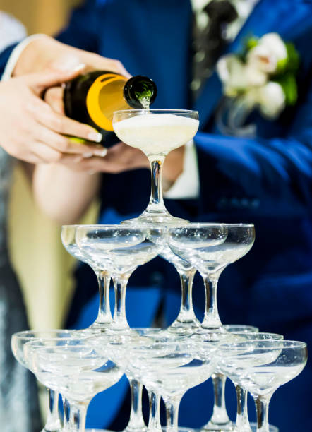 istock A couple holding champagne bottle while pouring liquor inside the glasses 1161924506