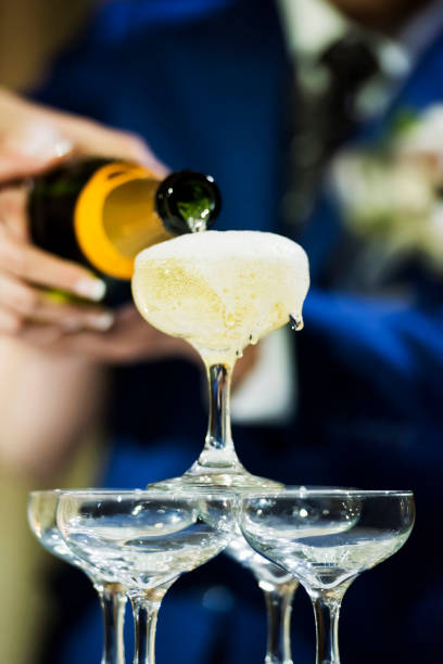 istock A couple holding champagne bottle while pouring liquor inside 1161924560