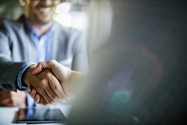 Close up of businessmen came to an agreement in the office. Close up of unrecognizable businessmen shaking hands on a meeting in the office. Copy space. trust stock pictures, royalty-free photos & images