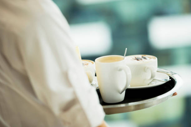 istock Waiter serving coffee and juice on the tray 1161924859