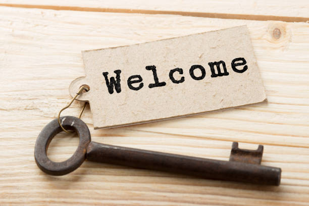 istock Welcome - tag on vintage key, check-in hotel concept 1161924918