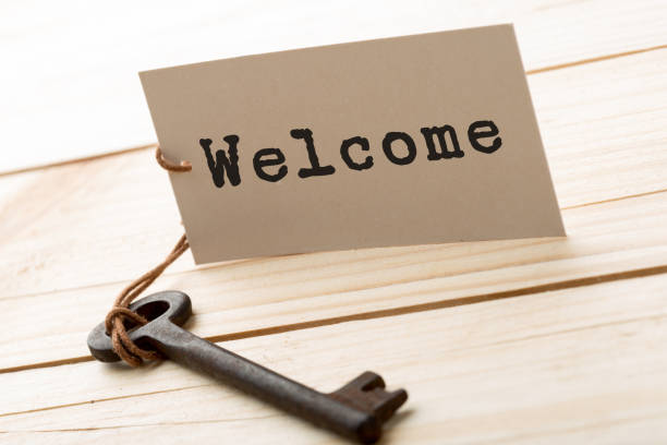istock Welcome - tag on vintage key, check-in hotel concept 1161924926