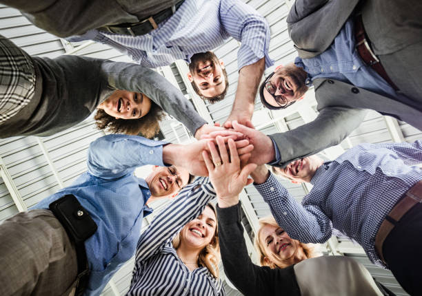istock Below view of happy business team uniting their hands. 1161926004