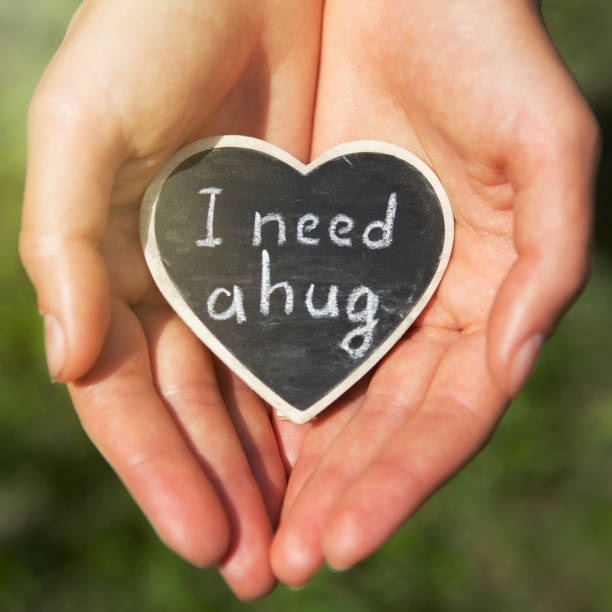 istock Little heart with I Need a Hug phrase in a hands. Sharing a Hug concept 1161926485