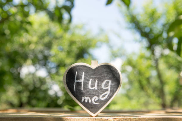 istock Hug me hand drawing phrase on a heart, Share a Hug Day concept 1161926493