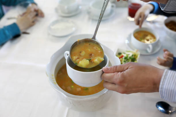 istock Person pouring soup 1161926532