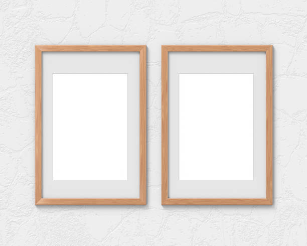 istock Set of 2 vertical wooden frames mockup with a border hanging on the wall. Empty base for picture or text. 3D rendering. 1161927427