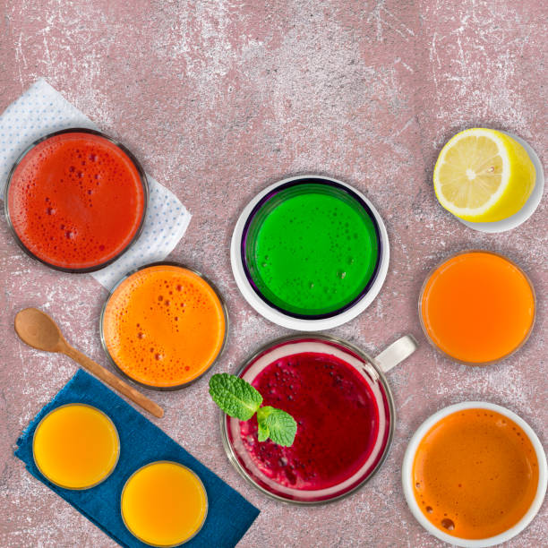 istock Set of different vegetable juices and fruit drinks, mint leaf and lemon on pink stone background.  Concept of healthy eating and drinks. Top view. Copy space. 1161927880