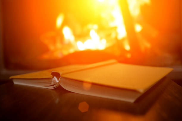 istock open book on the background of a burning fireplace 1161929006