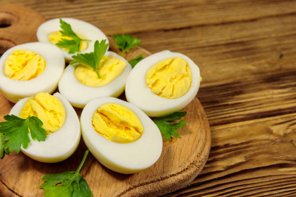 istock Boiled eggs with parsley on cutting board on a wooden table 1161930472