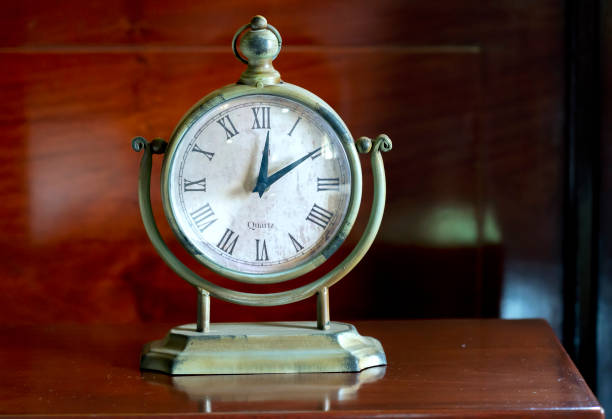 Vintage clock on the table in the bedroom. They see time and alarms dating back to the 19th century