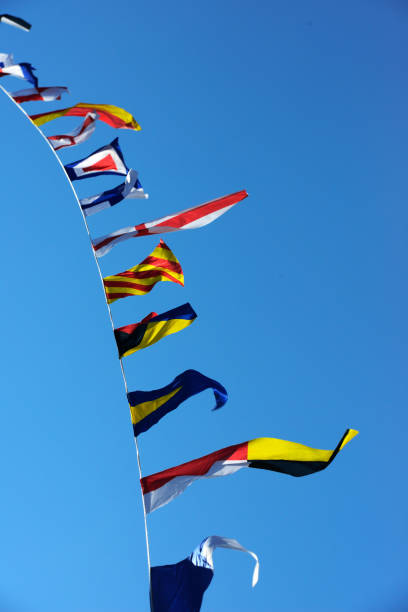 istock sea flags fluttering in the wind against a blue sky 1161934256