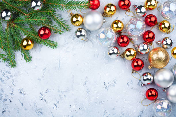 istock Christmas festive frame, New Year decorative border, shiny gold, silver, red balls decorations on green fir branches on light blue frosty background top view, winter holidays greeting card, copy space 1161936338