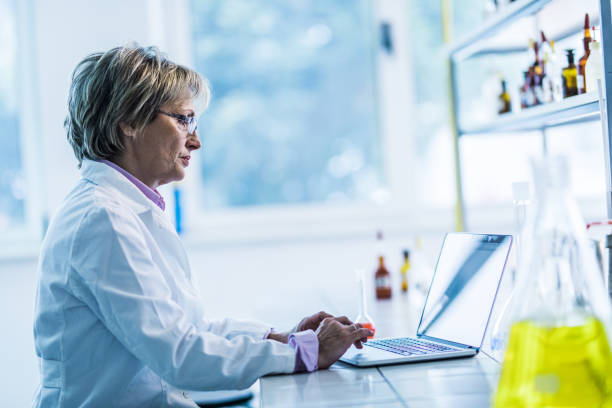 istock Mature forensic scientist working on laptop in a laboratory. 1161938394