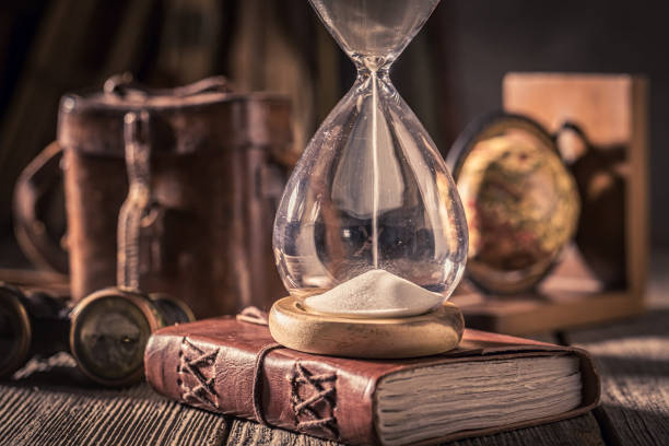 istock Old journal and hourglass with binocular, compass and books 1161940575