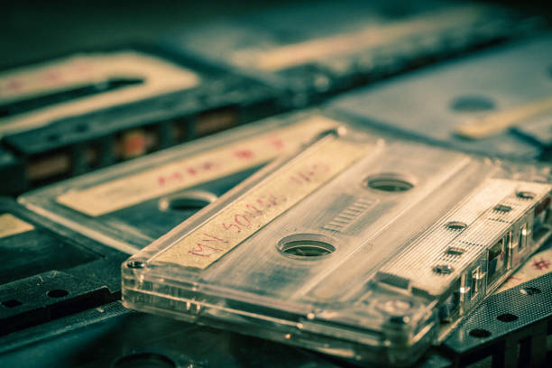 istock Closeup of old audio cassettes on grey table 1161941172