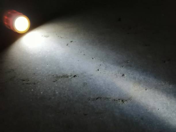 istock Light coming out from a torch spreading on the floor. 1161944487