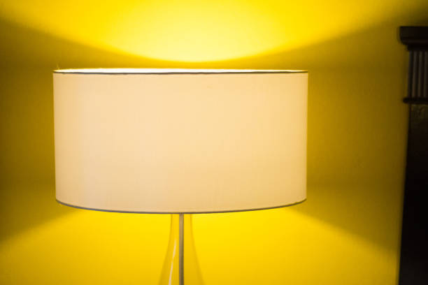 istock Yellow lamp with warm yellow light in bedroom 1161945724