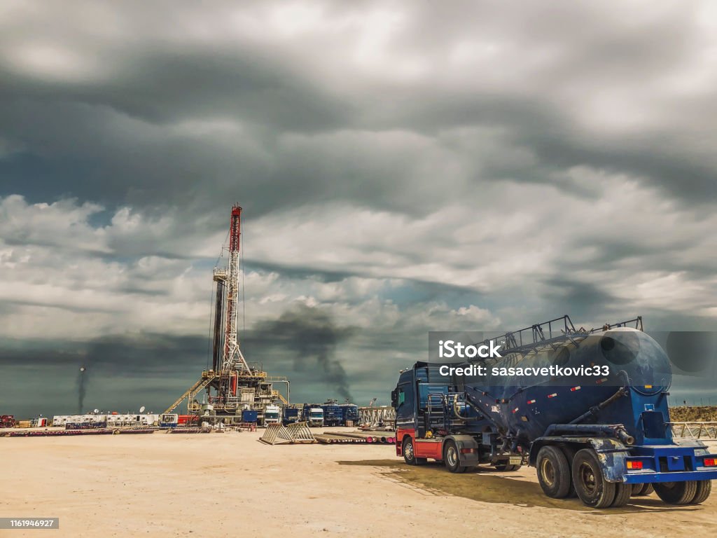 Fracking Oil Rig at sunset Back Lit, Business Finance and Industry, Construction Platform Fracking Stock Photo