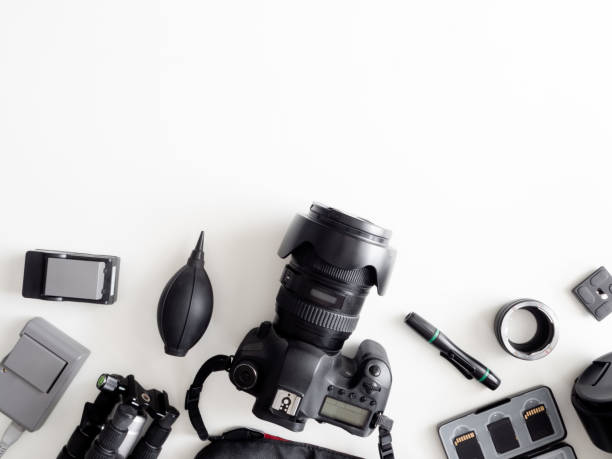 istock top view of work space photographer with digital camera, flash, cleaning kit, memory card, tripod and camera accessory on white table background 1161947096