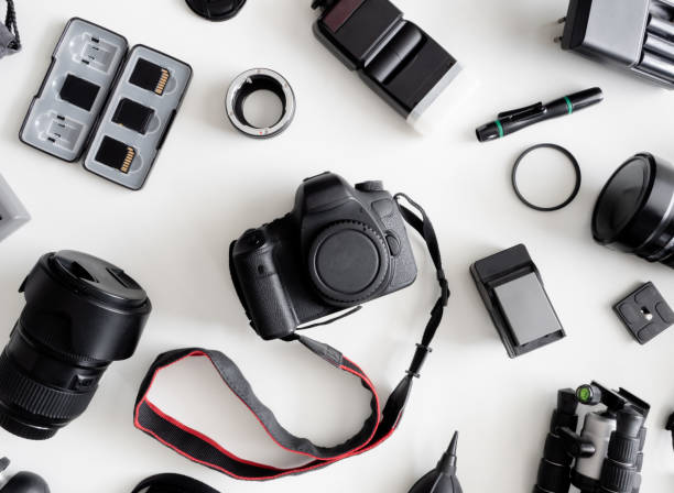 istock top view of work space photographer with digital camera, flash, cleaning kit, memory card, tripod and camera accessory on white table background 1161947102
