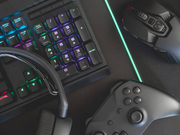 istock e-sport concept, top view a gaming gear, mouse, keyboard, joystick, headset, mobile joystick, in ear headphone and mouse pad on black table background. 1161947122