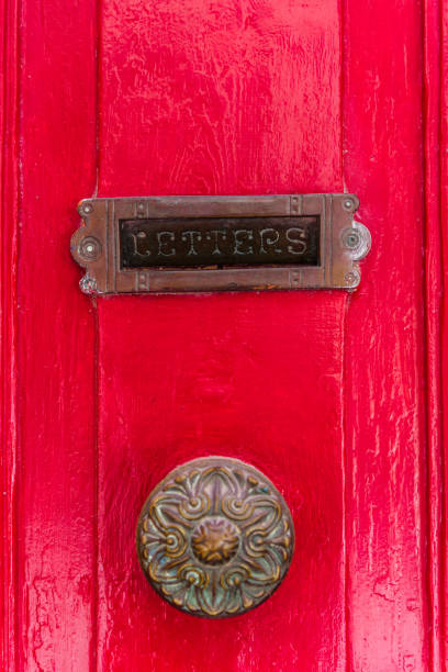 istock Letter box on the red door with an ancient handle 1161947130
