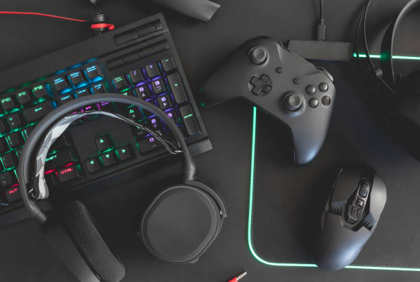 istock e-sport concept, top view a gaming gear, mouse, keyboard, joystick, headset, mobile joystick, in ear headphone and mouse pad on black table background. 1161947175