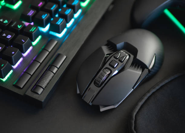 istock e-sport concept, top view a gaming gear, mouse, keyboard, joystick, headset, mobile joystick, in ear headphone and mouse pad on black table background. 1161947177