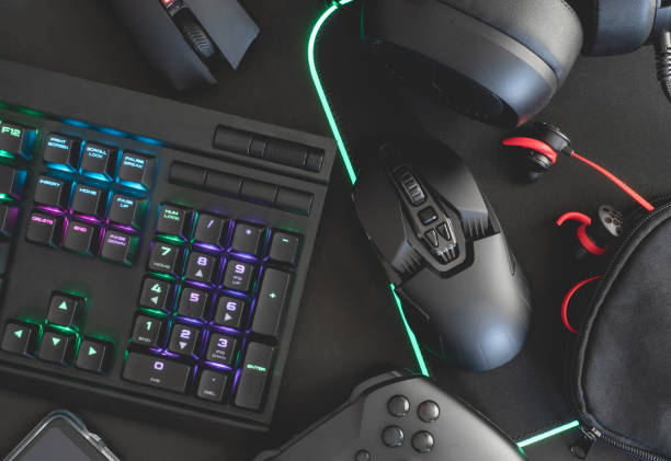 istock e-sport concept, top view a gaming gear, mouse, keyboard, joystick, headset, mobile joystick, in ear headphone and mouse pad on black table background. 1161947180