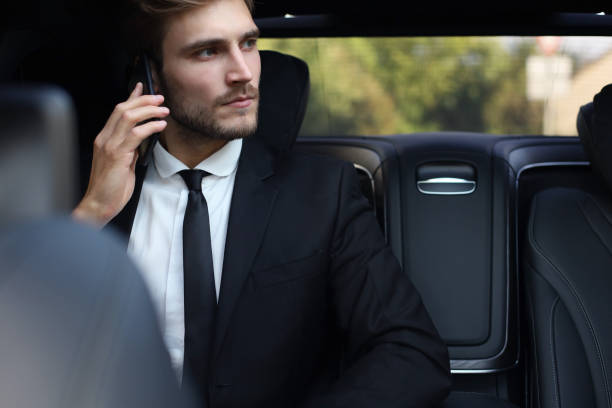 istock Thoughtful confident businessman talking on the phone while sitting in the car. 1161948052