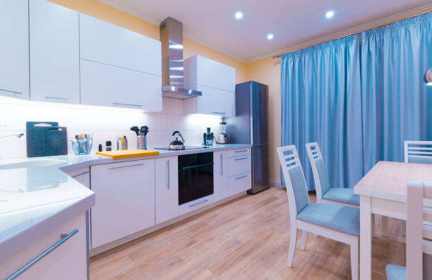 istock Interior. Kitchen modern, light yellow walls, blue curtains 1161949249