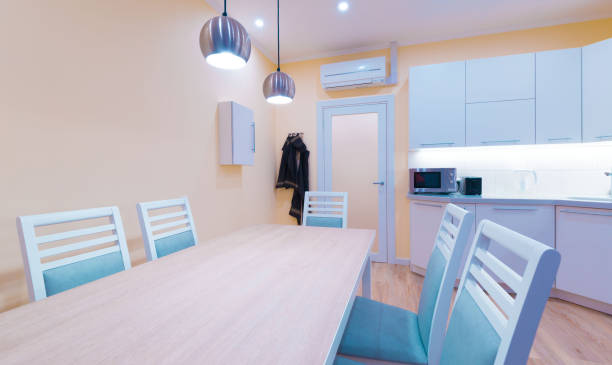 istock Interior. Kitchen modern, light yellow walls, white furniture 1161949385