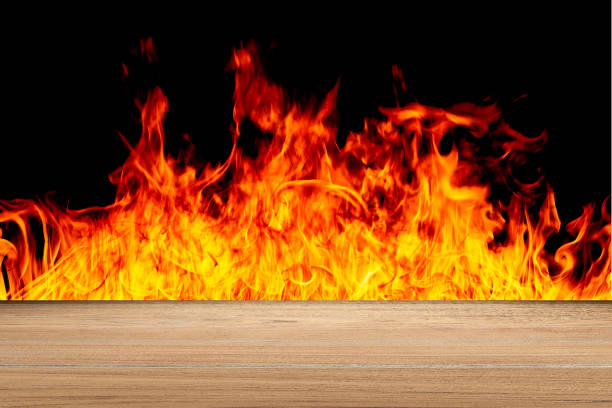 istock Old Brown wood table with flying fire sparks texture on dark background 1161950816