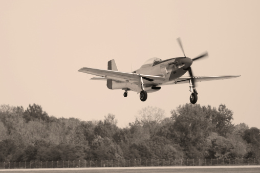 US WWII fighter taking off. P-51 Mustang.