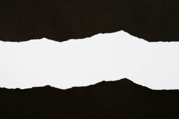istock pieces of black paper on white background with copy space 1161951052