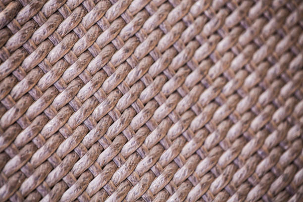 brown artificial rattan pattern background of structure close-up. furniture backdrop. selective focus. - fake rattan imagens e fotografias de stock