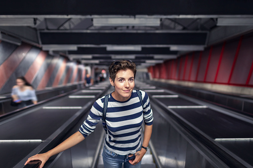 Woman on an escalator at a subway station