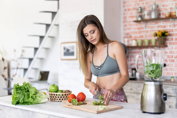 istock Healthy woman making a salad at home 1161957563