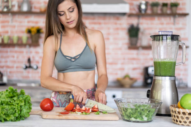 istock Healthy woman making a salad at home 1161957565