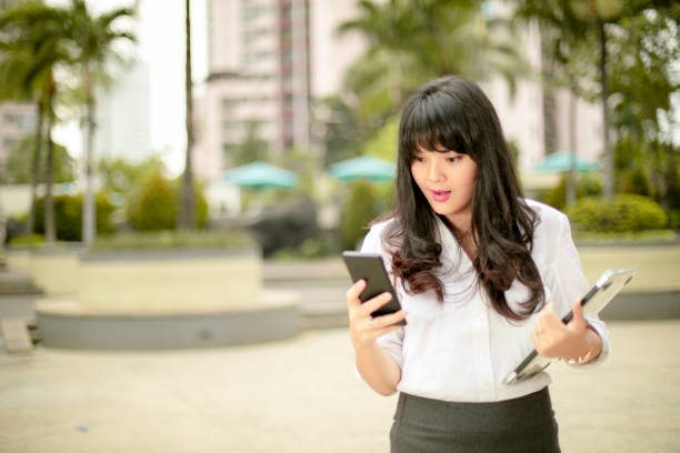 istock business woman  with smartphone 1161963981