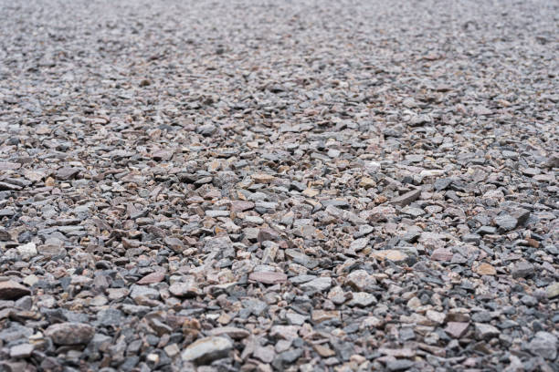 Grits path background with shallow depth of field. Gravel path as a background with shallow depth of field. pebble driveway stock pictures, royalty-free photos & images